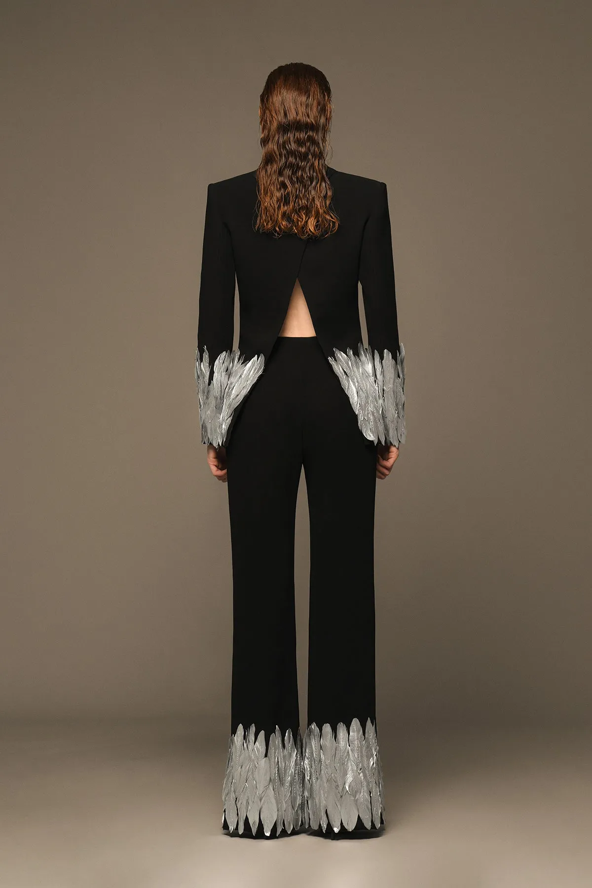 Structured black suit with silver painted feathers